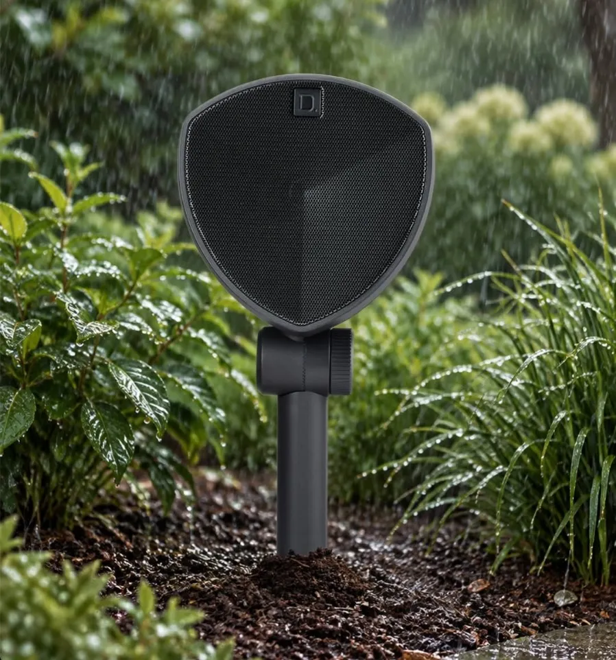 LS-400 speaker standing in a garden bed during heavy rain